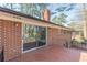 Exterior shot of a paver patio with iron railing, a brick facade and sliding glass door at 407 North Ave, Atlanta, GA 30354