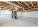 Unfinished basement with exposed ceiling and stairs at 407 North Ave, Atlanta, GA 30354