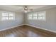 A bedroom featuring hardwood floors, neutral paint, a ceiling fan, and windows offering natural light at 407 North Ave, Atlanta, GA 30354