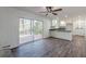 Open floor plan with luxury vinyl plank floors, kitchen with breakfast bar, and slider to backyard at 407 North Ave, Atlanta, GA 30354
