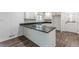 Bright, renovated kitchen featuring white cabinets, dark countertops, and modern stainless steel appliances at 407 North Ave, Atlanta, GA 30354