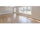 Sun-filled living room featuring hardwood floors and large windows overlooking the landscaped yard at 407 North Ave, Atlanta, GA 30354