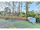 Fenced backyard with storage shed and mature trees at 4087 Signal Rdg, Lilburn, GA 30047