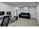 Finished basement featuring durable flooring, a comfortable sofa and workout equipment at 4087 Signal Rdg, Lilburn, GA 30047