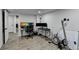 Finished basement with modern flooring featuring a work area with multiple monitors and workout equipment at 4087 Signal Rdg, Lilburn, GA 30047