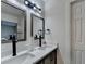 Bathroom features a double sink vanity, framed mirrors, modern lighting, and dark hardware at 4087 Signal Rdg, Lilburn, GA 30047