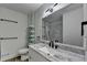 Bathroom features a marble countertop vanity, sleek lighting, and modern tile in the shower at 4087 Signal Rdg, Lilburn, GA 30047