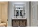 Bathroom features a double vanity with stone countertops, vessel sinks, and modern lighting at 4087 Signal Rdg, Lilburn, GA 30047