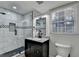 Modern bathroom featuring a glass shower, dark vanity, and stylish fixtures at 4087 Signal Rdg, Lilburn, GA 30047