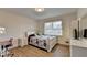 Bright bedroom featuring hardwood floors, a large window, a full-sized bed, and desk for studying at 4087 Signal Rdg, Lilburn, GA 30047