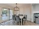 Cozy dining area with backyard access, updated lighting, and views of the outdoor deck at 4087 Signal Rdg, Lilburn, GA 30047