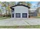 Two-story home featuring a 2-car garage, a private deck, and clean white brick at 4087 Signal Rdg, Lilburn, GA 30047