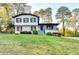 Attractive two-story home with white siding, black trim, a covered porch, and a well-manicured front yard at 4087 Signal Rdg, Lilburn, GA 30047