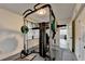 Home gym with full weight station, bench and mirrored wall is perfect for fitness enthusiasts at 4087 Signal Rdg, Lilburn, GA 30047