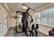 Bright home gym with full weight station and rubber flooring provides a private workout space at 4087 Signal Rdg, Lilburn, GA 30047