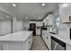 View of kitchen from living room, showing the open floor plan, island, and white cabinetry at 4087 Signal Rdg, Lilburn, GA 30047