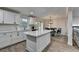 The bright kitchen has a breakfast area with backyard deck access, a center island and modern appliances at 4087 Signal Rdg, Lilburn, GA 30047