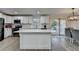 Bright kitchen features white cabinets, an island with quartz countertops, and stainless steel appliances at 4087 Signal Rdg, Lilburn, GA 30047