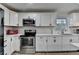 Close-up shot of the modern kitchen, highlighting the stainless steel appliances and white cabinetry at 4087 Signal Rdg, Lilburn, GA 30047
