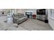 Open-concept living area with a large sofa, a dining area, and natural light from sliding glass doors at 4087 Signal Rdg, Lilburn, GA 30047