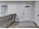Cozy living room featuring a plush gray sofa, wood-look floors, and a bright window at 4087 Signal Rdg, Lilburn, GA 30047