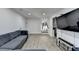 Open living room with hardwood floors, stairs, and a large TV at 4087 Signal Rdg, Lilburn, GA 30047
