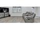 Comfortable living room with a TV, a window with blinds, and a contemporary sofa at 4087 Signal Rdg, Lilburn, GA 30047