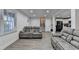 Open living space featuring sofas, sleek flooring, and recessed lighting for a modern touch at 4087 Signal Rdg, Lilburn, GA 30047