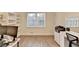 Office with hardwood floors, a large window and built in white shelves and desk at 4087 Signal Rdg, Lilburn, GA 30047