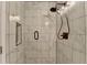 Beautifully tiled marble shower with bronze fixtures and soap niche at 4087 Signal Rdg, Lilburn, GA 30047