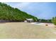 Wide backyard highlighting a pool, poolhouse, and lush surroundings, providing a tranquil escape for relaxation at 1698 Little Fox Ln, Dacula, GA 30019