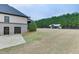 Spacious backyard showcasing a pool, poolhouse, and ample green space, providing a serene and private retreat at 1698 Little Fox Ln, Dacula, GA 30019