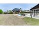 Inviting backyard with a sparkling pool, patio, and lush green space, perfect for outdoor enjoyment and entertaining at 1698 Little Fox Ln, Dacula, GA 30019