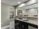 Finished basement bar offers granite counters, dark cabinets, and a stainless steel sink at 1698 Little Fox Ln, Dacula, GA 30019
