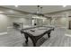 Finished basement game room with pool table and bar area with seating for entertaining at 1698 Little Fox Ln, Dacula, GA 30019