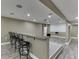 Basement bar area complete with granite countertops, seating, and media space with projector at 1698 Little Fox Ln, Dacula, GA 30019
