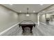 Basement game room boasts a pool table and a light fixture providing ample illumination at 1698 Little Fox Ln, Dacula, GA 30019