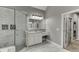 Bright bathroom with tiled shower and vanity with marble countertops at 1698 Little Fox Ln, Dacula, GA 30019