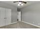 Neutral bedroom with carpet, a ceiling fan, and white doors and trim at 1698 Little Fox Ln, Dacula, GA 30019
