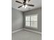 Bright bedroom showcasing a ceiling fan, shuttered windows, and neutral carpeting at 1698 Little Fox Ln, Dacula, GA 30019