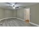 Bedroom with neutral color walls, ceiling fan, door to closet and luxury vinyl flooring at 1698 Little Fox Ln, Dacula, GA 30019