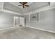 Huge bedroom featuring a tray ceiling, neutral carpet, and a mount for a TV at 1698 Little Fox Ln, Dacula, GA 30019