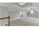Large bonus room with plush carpet and dormer windows providing natural light at 1698 Little Fox Ln, Dacula, GA 30019