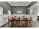 Elegant dining room with gray walls, white trim, and a large wooden table at 1698 Little Fox Ln, Dacula, GA 30019