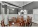 Formal dining room with wainscoting, decorative lighting, and hardwood floors at 1698 Little Fox Ln, Dacula, GA 30019