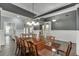 Open dining area with hardwood floors, wainscoting, and views into other living spaces at 1698 Little Fox Ln, Dacula, GA 30019
