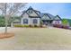 Charming home featuring a brick facade, lush landscaping, and a well-maintained lawn at 1698 Little Fox Ln, Dacula, GA 30019