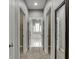 Bright hallway with plush carpet and French doors leading to a luxurious bathroom with natural light at 1698 Little Fox Ln, Dacula, GA 30019