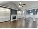 Spacious living room with a fireplace, built-in bookshelves, and hardwood flooring at 1698 Little Fox Ln, Dacula, GA 30019