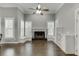 Cozy living room with a fireplace, built-in shelves, and large windows with light-blocking shutters at 1698 Little Fox Ln, Dacula, GA 30019